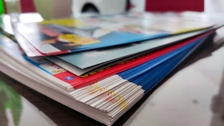a pile of predominant blue brochures with a few white and red huesの写真素材