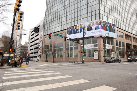 Atlanta, Ga / USA - 02 25 20: People standing on the side walks in Atlanta with traffic and...