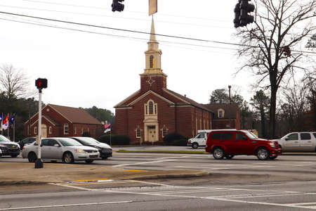 Dekalb County, Ga / USA - 02 25 20: Traffic at a 4 way and a church in the distance