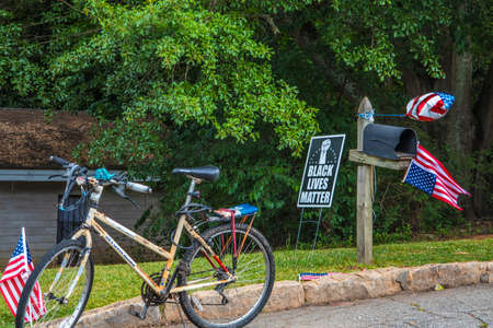Doraville, Ga / USA - 07 06 20: Black Lives Matter yard sign, a bicycle and an American flagのeditorial素材