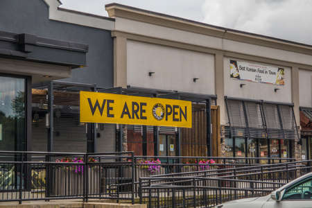 Doraville, Ga / USA - 07 06 20: View of a we are open banner with stairs and black railsのeditorial素材