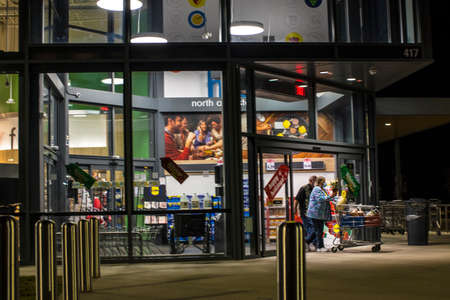 Augusta, Ga / USA - 11 21 20: LIDL Grocery Supermarket at night seniors exiting wearing face masks