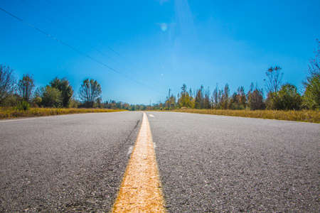 Rural empty road in the country in Georgia and clear blue sky
