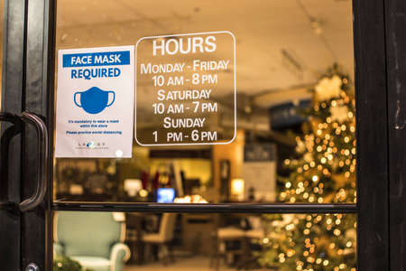 Augusta, Ga USA - 11 22 20: LaZBoy Furniture Gallery at night store hours and covid-19 sign and...