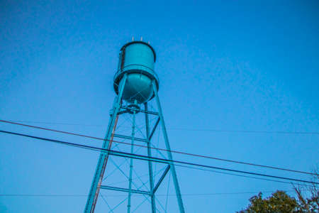 An old water tower and trees with cloudy skies in the south close upの写真素材
