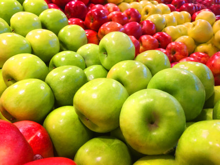 Rows of apples red golden and granny smith colorfulの写真素材