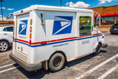 Gwinnett, County USA - 05 31 20: USPS mail delivery truck back corner view