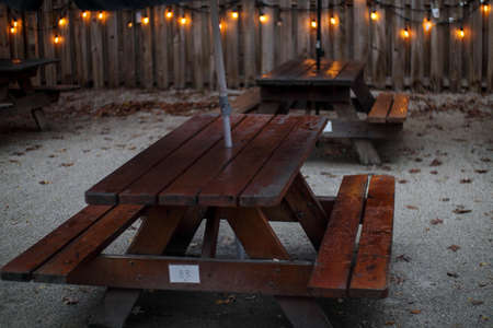 Picnic tables and lights with a wooden fence outdoors during the Winter in Georgia