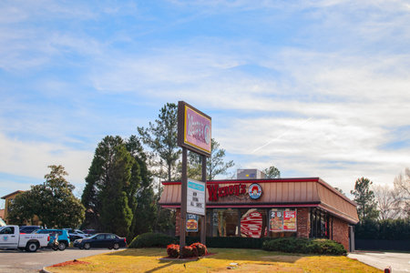 Augusta, Ga USA - 01 06 21: Wendys fast food drive thru restaurant building and street sign and...