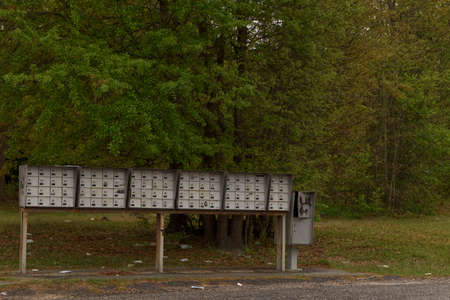 Augusta, Ga USA - 04 10 21: A row of metal grouped mailboxes for an apartment complex with litter...
