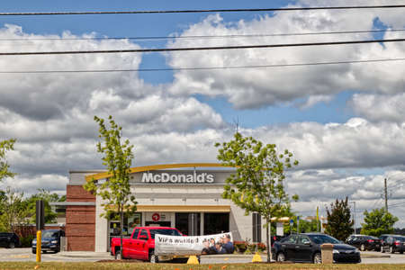 Augusta, Ga USA - 04 25 21: McDonalds front facade and VIP now hiring banner lines at drive thru - Lewiston Roadのeditorial素材
