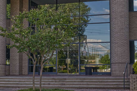 Modern brick walls and column gold trim doors with steps and entrance
