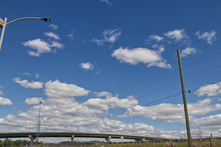 Highway bridge light post and traffic with clouds and beautiful blue sky background in Augusta...
