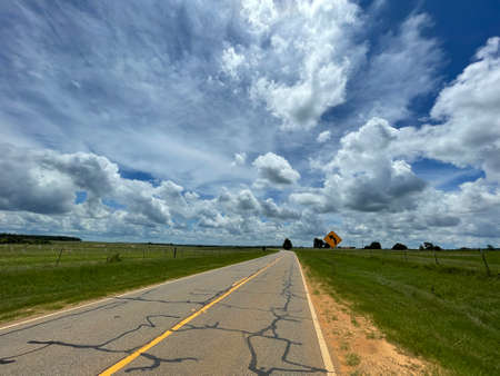 Cracked old rural road in Georgia during the summer in the countryの写真素材