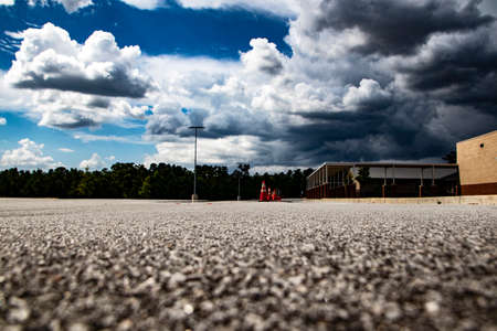 Ground view of a building and orange and white cones