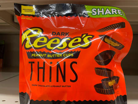 Grovetown, Ga USA - 01 01 22: Bags of candy in a retail grocery store Reeces thins
