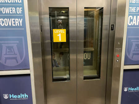 Augusta, Ga USA - 12 13 21: A hospital parking deck urban spooky elevator sign on doorのeditorial素材