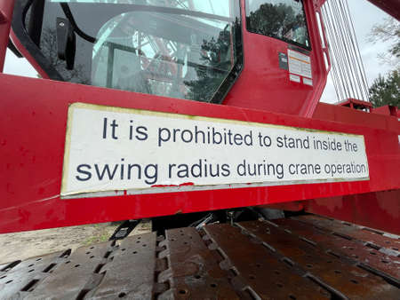 Augusta, Ga USA - 03 19 22: Manitowoc Red Crane Construction scene cloudy rainy day prohibited signのeditorial素材