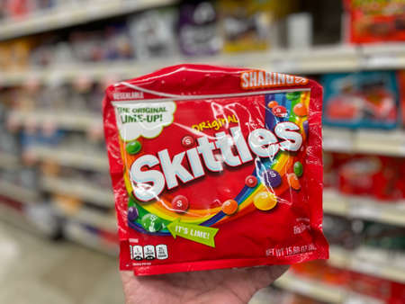 Grovetown, Ga USA - 05 10 22: Retail store candy hand holding original Skittles