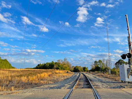 Burke County, Ga USA - 01 25 21: Train track in a rural country area blue sky and cloudsのeditorial素材