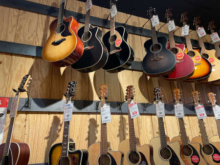 Augusta, Ga USA - 07 25 21: Guitar Center retail store looking up at acoustic guitars