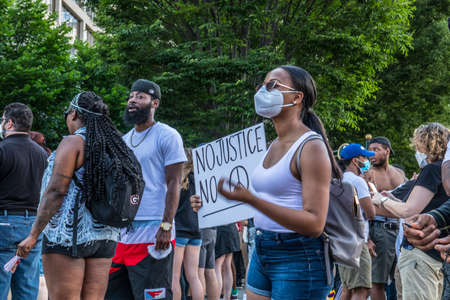 Atlanta, Ga USA - 05 30 20: Protesters downtown Atlanta wearing a face mask and holding sign