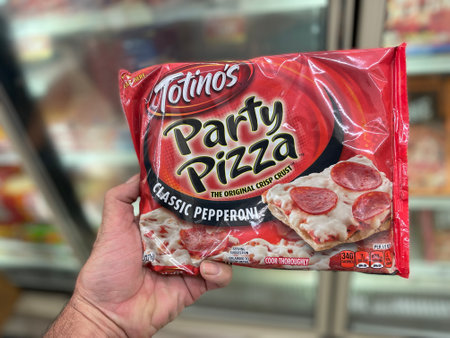Grovetown, Ga USA - 06 21 22: Retail store hand holding Totinos pizza