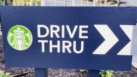Augusta, Ga USA - 06 25 23: New Starbucks drive thru sign in the rainのeditorial素材