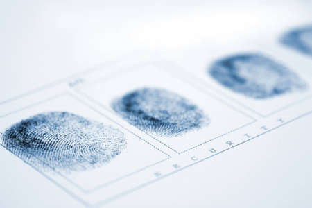A fingerprint on a white sheet of paperの写真素材
