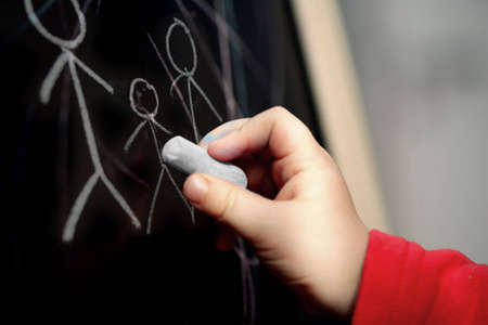 Young child drawing a familyの写真素材