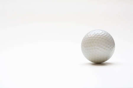 A golfball isolated with shadowの写真素材