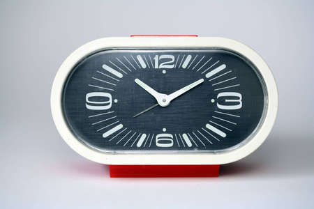 an alarm clock and a white background
