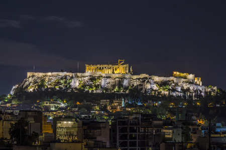 night view of the athens acropolis and modern buildings that surround the sameのeditorial素材