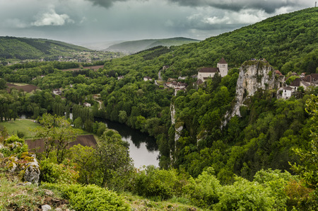 South of France we see the winding river Lot between mountains as it passes through the old medieval village of Saint-Cirq-Lapopieの写真素材