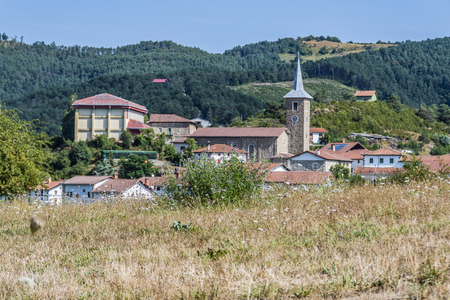 landscape in the Navarrese Pyrenees you can see the village Erro in which the tower of the parish of San Esteban stands out. Navarre Spainの写真素材