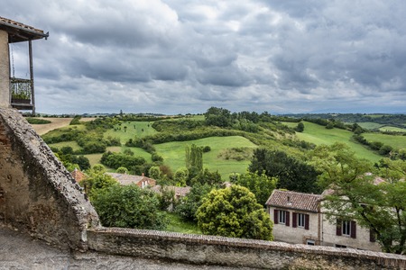 Viewpoint of the old village of Saint Yvars in the canton of Le Fossat region of Midi-Pyrenees and landscape of hills and plowed fields. Pamiers Franceの写真素材