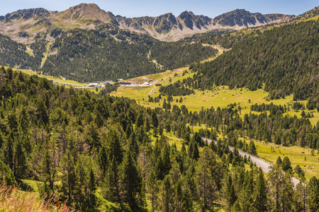 Typical landscape of the Pyrenees with its green mountain slopes its pine forests and rocks. Andorra...