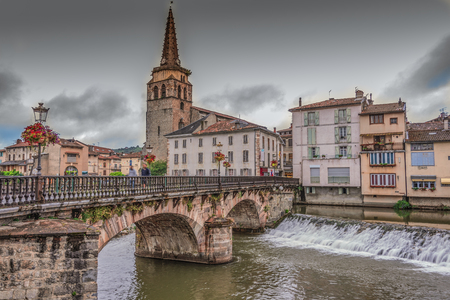 Bridge over the river Salat and church in the center of the village of Saint Girons. Ariege Franceの写真素材