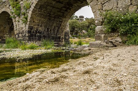 Rio Tormes as it passes through an old medieval bridge. Ledesma Salamanca Spainの写真素材