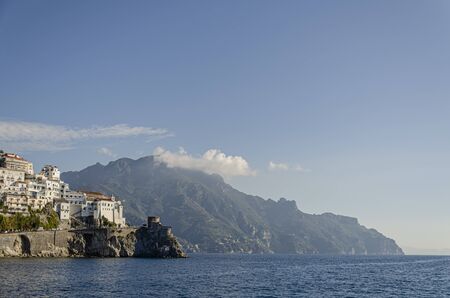 view from the Mediterranean of one of the many villas surrounded by mountains on the Amalfi coast. Campania. Italyの写真素材