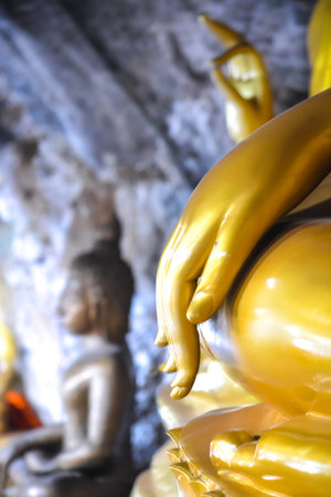 Close up image of golden Buddha hand in a temple Thailandの写真素材