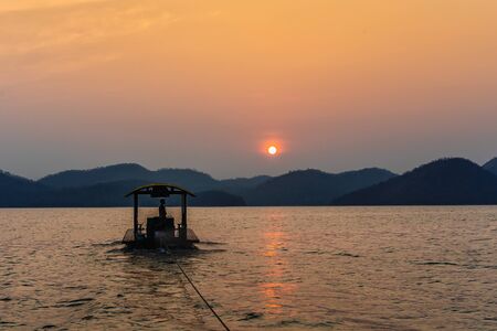 Landscape of wooden raft floating on river view in the morning sunrise at Srinakharin Dam of Kanchanaburi in Thailandの写真素材
