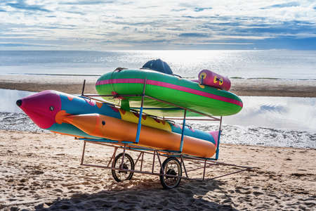 Colorful banana boats on wheels on the beach for tourists travel on summer vacation in the sunrise...
