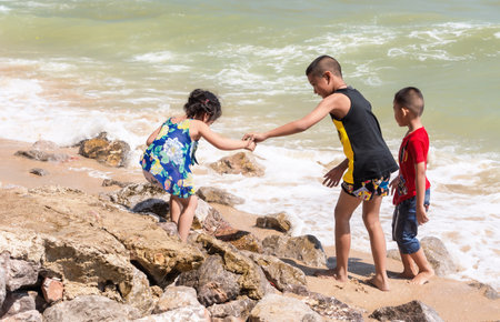 Phetchaburi, Thailand-January 20,2021: Undefined Asian adorable children playing on beach on summer...