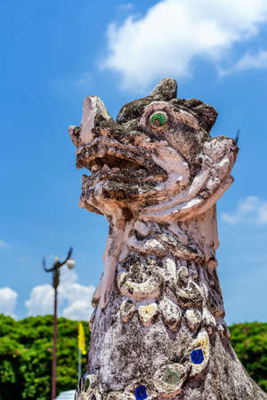 Nan, Thailand - July 28, 2021: Beautiful lion head sculpture with blue sky background in front of...