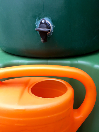 Big green waterbath for rainwater with watering can in the gardenの写真素材