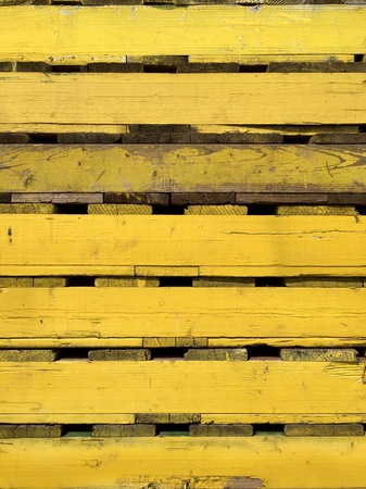 Closeup of several yellow wooden pallets for transportationの写真素材