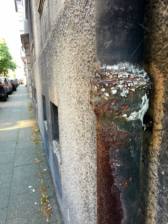 Very old and rusty down pipe on residential building