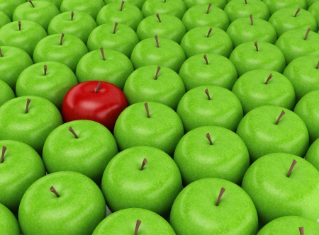 One red apple selected on the background of green applesの写真素材