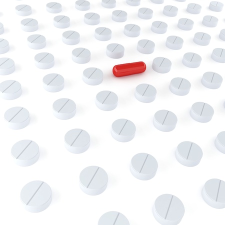 Tablets and red pill on the white backgroundの写真素材